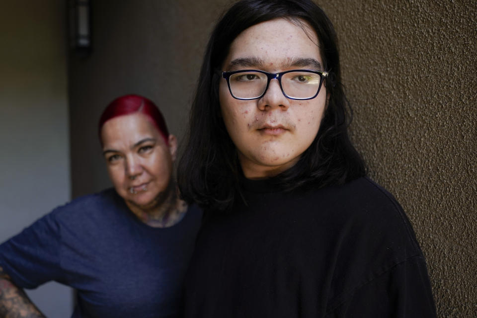 Juan Ballina, right, stands with his mother, Carmen Ballina near their home Friday, July 28, 2023, in San Diego. Juan missed 94 days of school in 2022 because he didn't have a nurse to attend class with him. He has epilepsy and requires a trained staffer to be nearby to administer medication in case he seizes. His usual nurse was out for her own medical needs and the district couldn't find a replacement. (AP Photo/Gregory Bull)