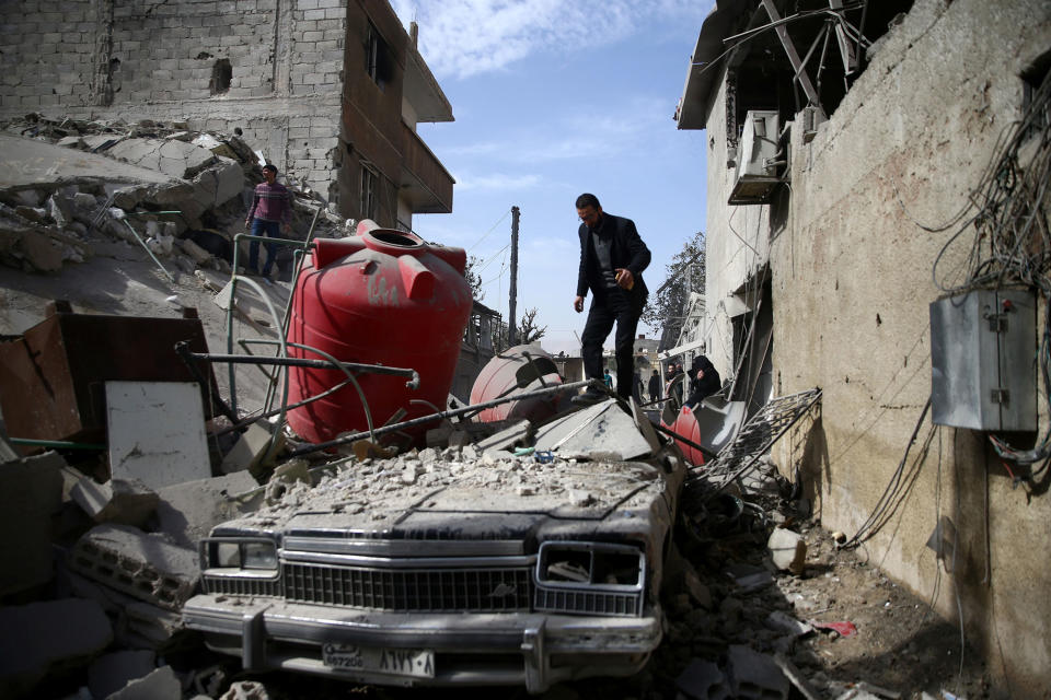 <p>Children are seen near rubble after an air raid in the besieged town of Douma in eastern Ghouta in Damascus, Syria, Feb. 6, 2018. (Photo: Bassam Khabieh/Reuters) </p>