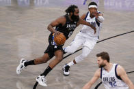 Brooklyn Nets guard James Harden (13) drives past Dallas Mavericks guard Josh Richardson during the second half of an NBA basketball game Saturday, Feb. 27, 2021, in New York. (AP Photo/John Minchillo)