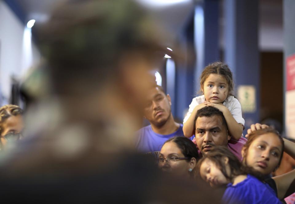 Venezuelan migrants wait in line to pass migration controls before the deadline on new regulations that demand passports from migrants, in Tumbes, Peru, Friday, June 14, 2019. Venezuelan citizens are rushing to enter Peru before the implementation of new entry requirements on migrants fleeing the crisis-wracked South American nation. (AP Photo/Martin Mejia)