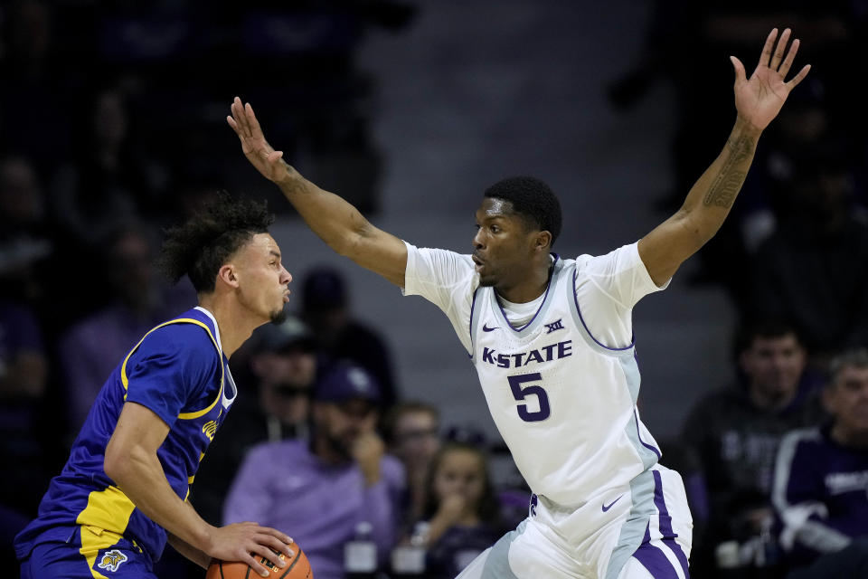 South Dakota State guard Zeke Mayo, left, looks to shoot over Kansas State guard Cam Carter (5) during the first half of an NCAA college basketball game Monday, Nov. 13, 2023, in Manhattan, Kan. (AP Photo/Charlie Riedel)