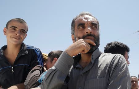 Islamic State prisoners, who were pardoned by a council that is expected to govern Raqqa once the group is dislodged from the Syrian city, stand in a truck in Ain Issa village, north of Raqqa, Syria, June 24, 2017. REUTERS/Goran Tomasevic