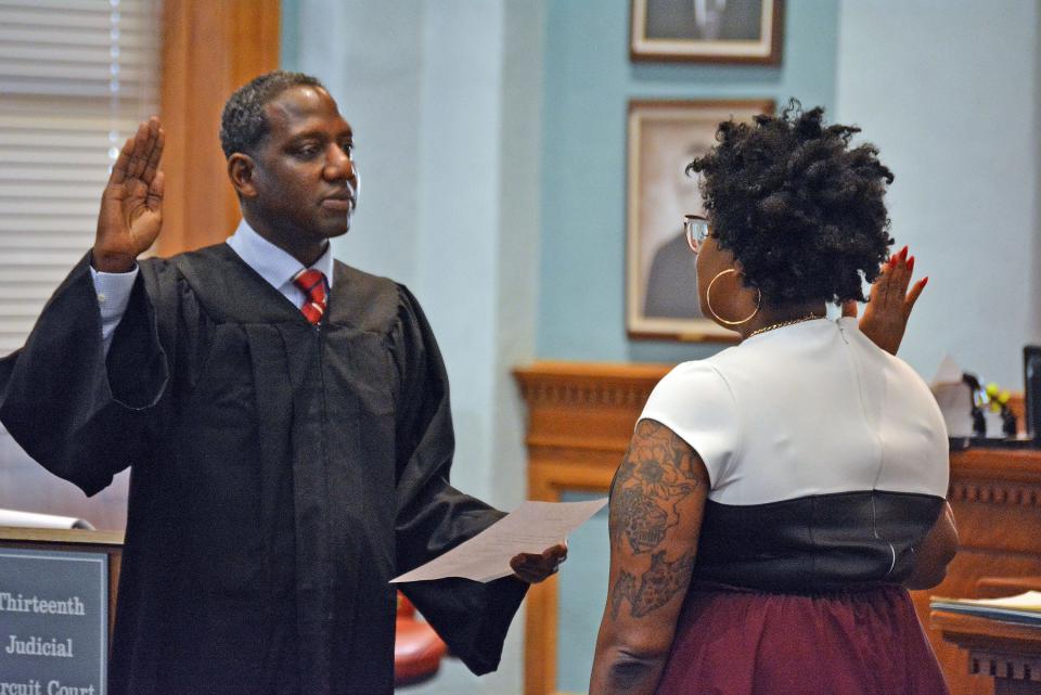 U.S. Magistrate Judge for the Western District of Missouri Willie J. Epps Jr. delivers the oath of office to Kayla Jackson-Williams, during a swearing-in ceremony Friday in the ceremonial courtroom of the Boone County Courthouse, making Jackson-Williams officially the judge for Division 10 of the 13th Judicial Circuit. 