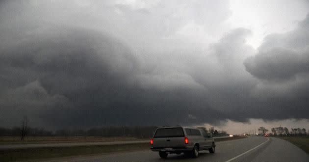 A storm moves over U.S. 20 on Thursday, April 9, 2015, in Belvidere, lll. At least one large tornado touched down Thursday night in central Illinois, causing significant damage. (AP Photo/Rockford Register Star, Max Gersh)