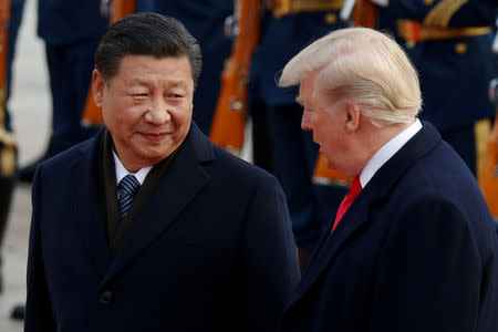 U.S. President Donald Trump takes part in a welcoming ceremony with China's President Xi Jinping at the Great Hall of the People in Beijing, China, November 9, 2017. REUTERS/Damir Sagolj/Files