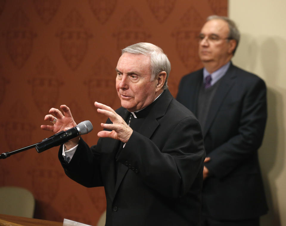 Bishop Francis Kane, Vicar General of the Archdiocese of Chicago, left, responds to a question about what the archdiocese knew about decades of clergy sex abuse allegations during a news conference Wednesday, Jan. 15, 2014, in Chicago. Standing behind Kane is archdiocese attorney John O’Malley. Victims’ attorneys, who have fought for years to hold the Catholic Church accountable for concealing crimes and sometimes reassigning priests to positions where continued to molest children, said they expect to receive the documents on Wednesday afternoon and make them public next week. (AP Photo/Charles Rex Arbogast)