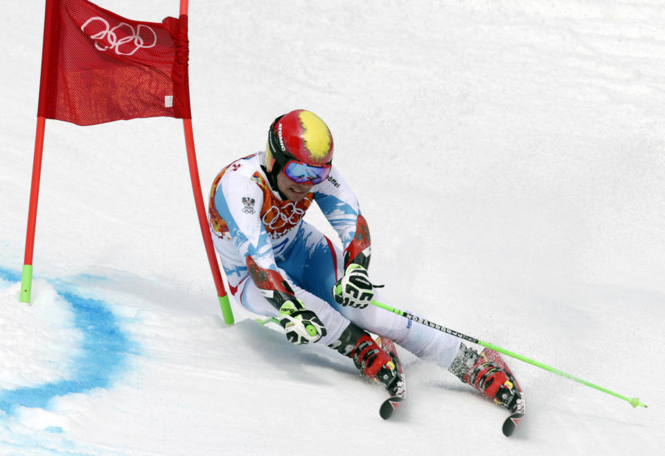 Austria's Marcel Hirscher skis past a gate during the first run of the men's giant slalom the Sochi 2014 Winter Olympics, Wednesday, Feb. 19, 2014, in Krasnaya Polyana, Russia. (AP Photo/Charles Krupa)