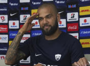 Brazilian Dani Alves salutes as he is presented as a new member of the Pumas UNAM, in Mexico City, Saturday, July 23, 2022. (AP Photo/Marco Ugarte)
