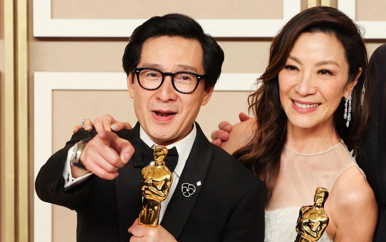 Best Supporting Actor Ke Huy Quan and Best Actress Michelle Yeoh pose with their Oscars - Reuters