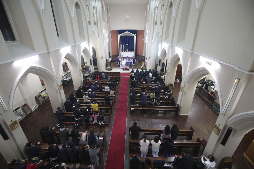 Worshippers pray during a Mass and vigil for the 39 victims found dead inside the back of a truck in Grays, Essex, at The Holy Name and Our Lady of the Sacred Heart Church, east London's Vietnamese church on Saturday, Nov. 2, 2019. All those killed were Vietnamese nationals, British police said. (Yui Mok/PA via AP)