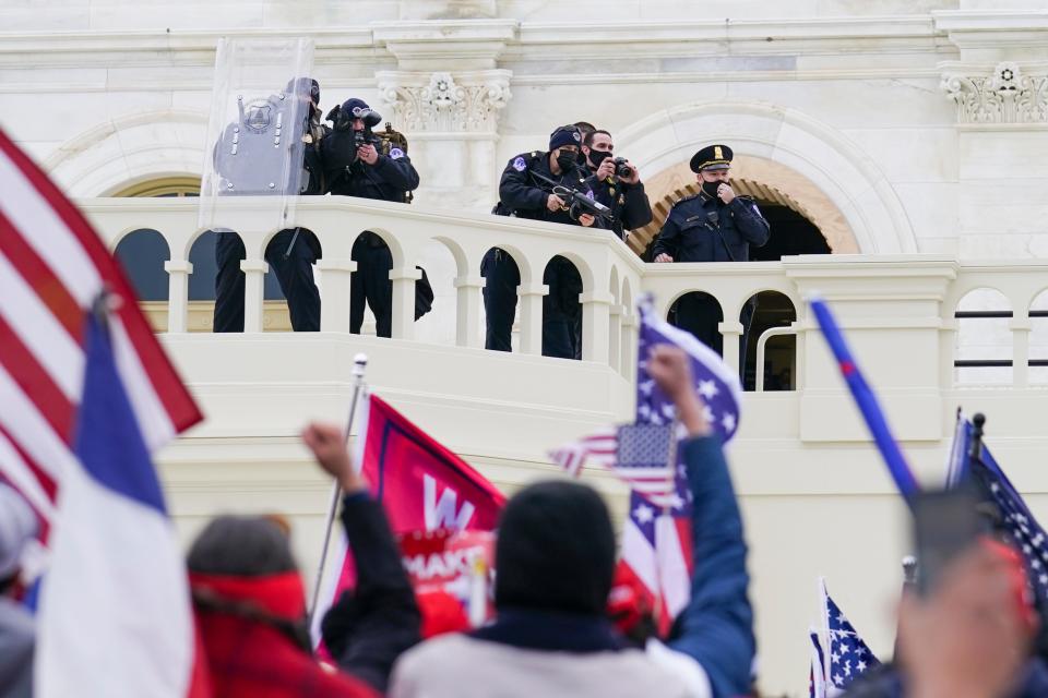 Supporters loyal to President Donald Trump clash with authorities before successfully breaching the Capitol building during a riot on the grounds, Wednesday, Jan. 6, 2021.