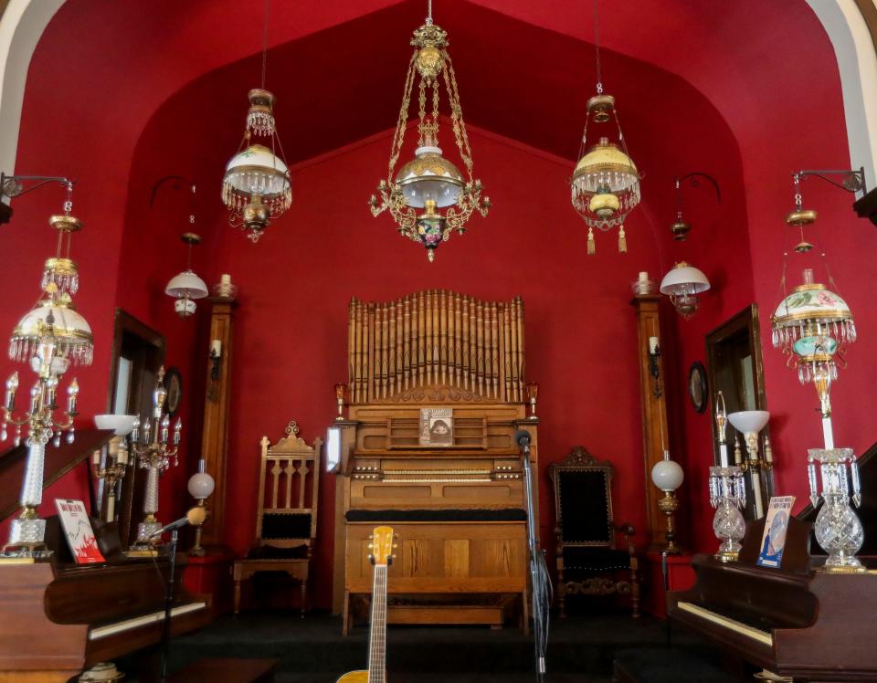 An antique pump organ is seen on the alter at the former Grace Baptist Church in Marshfield on Friday, September 8, 2023. Michael Kennelly bought the church in order to have space for his collection of organs and other antiques.