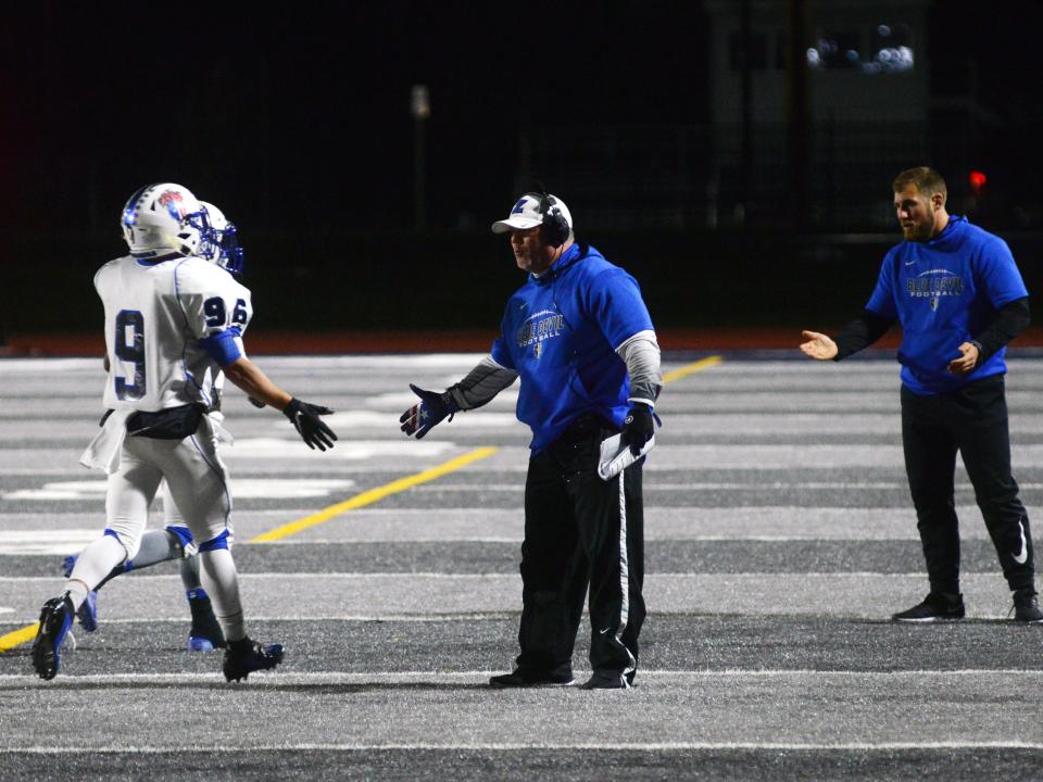 Head coach Chad Grandstaff congratulates Jordan Martin after scoring a touchdown during Zanesville's 52-28 win against host Marietta on on Nov. 2, 2019, at Marietta College's Don Drumm Stadium. Grandstaff resigned on March 16, 2022, after 15 years and 105 wins.