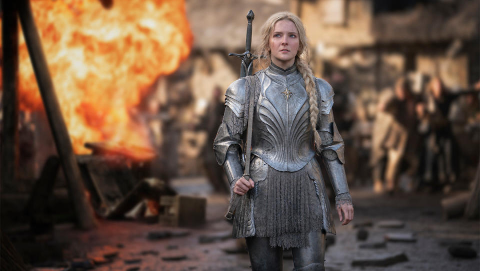 Galadriel in armor standing in front of a battlefield in The Rings of Power