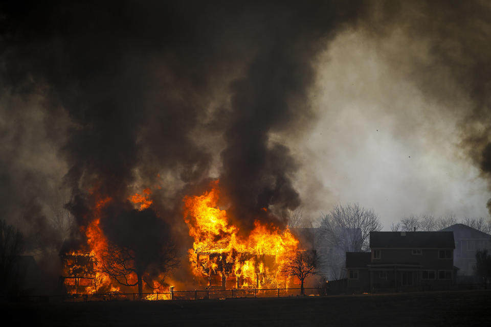 Two homes burn during a wildfire in the Centennial Heights neighborhood. (Marc Piscotty / Getty Images)