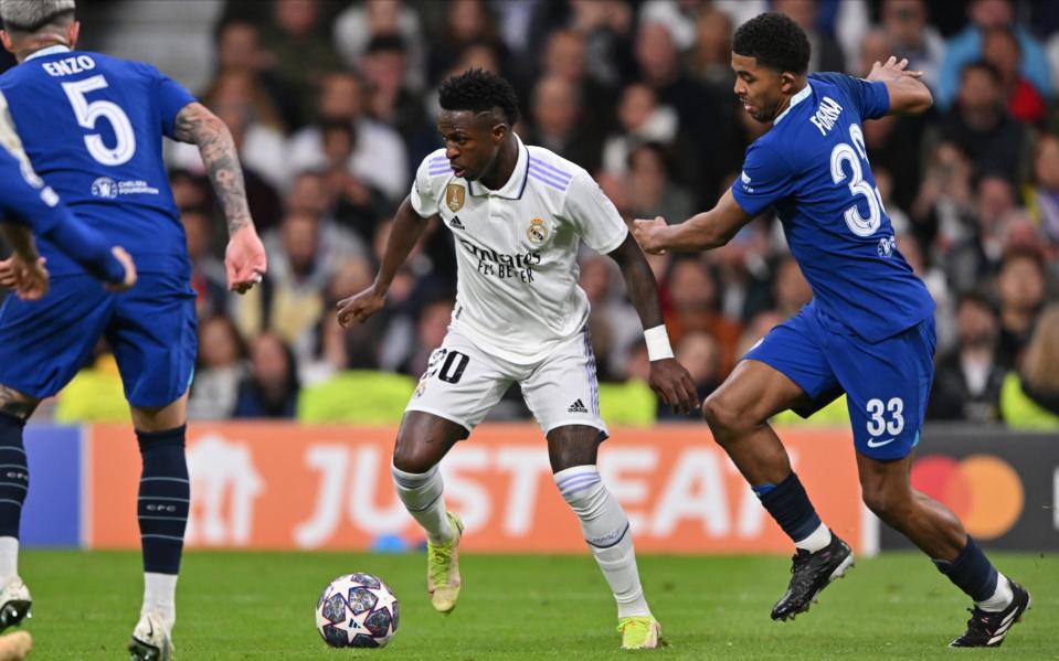 Vinicius Junior of Real Madrid and Wesley Fofana of Chelsea challenge during the UEFA Champions League Quarterfinal First Leg match between Real Madrid and Chelsea FC at Estadio Santiago Bernabeu - Getty Images/Will Palmer