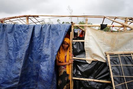 Ramida, 27, a Rohingya refugee woman, poses for a photograph in front of her house which has been destroyed by Cyclone Mora at the Balukhali Makeshift Refugee Camp in Cox’s Bazar, Bangladesh May 31, 2017. REUTERS/Mohammad Ponir Hossain