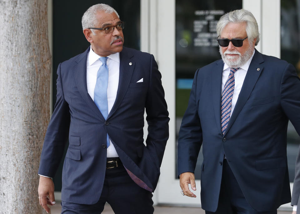 Carnival Corp. CEO Arnold Donald, left, and chairman Micky Arison walk to federal court, Wednesday, Oct. 2, 2019, in Miami. Top Carnival Corp. executives are back in court to explain what the world's largest cruise line is doing to reduce ocean pollution. (AP Photo/Wilfredo Lee)