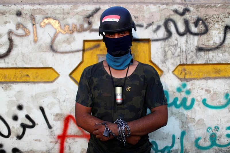 Hussein, an Iraqi demonstrator, poses for a photograph during the ongoing anti-government protests in Baghdad