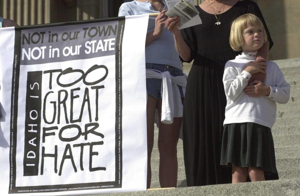 In this 2001 file photo, Rebecca Elise Russell, 4, holds the hand of her grandmother, Susan Curtis, chairwoman for the Ada County Human Rights Task Force, during a rally against hate at the Idaho Statehouse. About 100 people demonstrated on the Capitol steps to show their disgust with a burning cross found there early Monday. A Statehouse security guard discovered the cross made of 2-by-6 lumber roped to a railing on the steps leading to the Capitol’s second-floor entrances. It burned briefly.