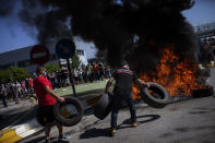 Nissan workers burn tires during a protest in front of the Nissan factory in Barcelona, Spain, Thursday, May 28, 2020. Japanese carmaker Nissan Motor Co. has decided to close its manufacturing plans in the northeastern Catalonia region, resulting in the loss of some 3,000 direct jobs. (AP Photo/Emilio Morenatti)