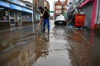 A man cleaning up the street in Pontypridd. (PA)