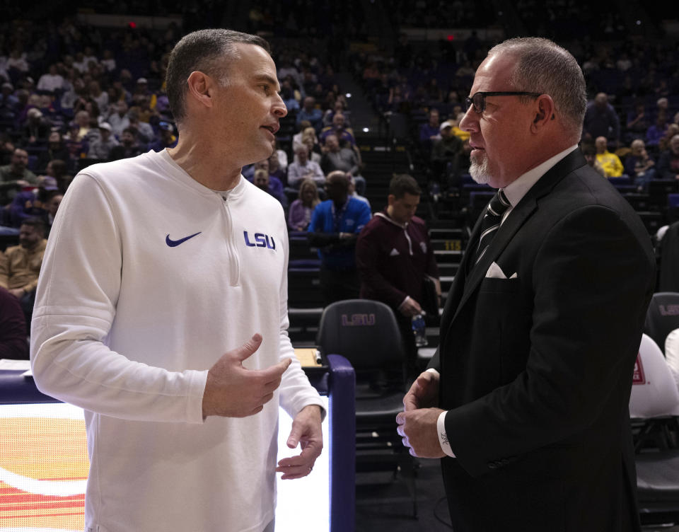LSU head coach Matt McMahon, left, and Texas A&M head coach Buzz Williams, right, talk on the court before the tipoff for an NCAA college basketball game Saturday, Jan. 20, 2024, in Baton Rouge, La. (Hilary Scheinuk/The Advocate via AP)