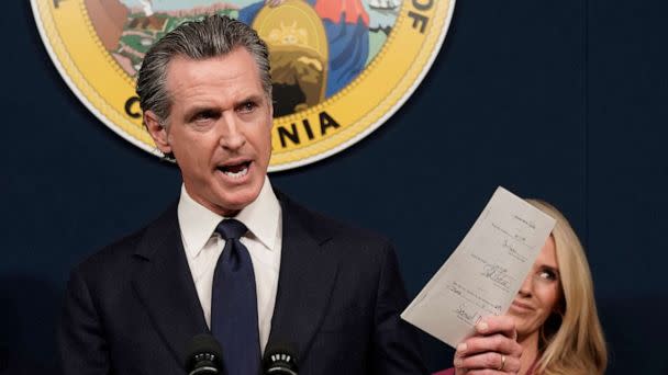 PHOTO: California Gov. Gavin Newsom displays a bill he signed during a news conference in Sacramento, Calif., June 24, 2022. (Rich Pedroncelli/AP, FILE)