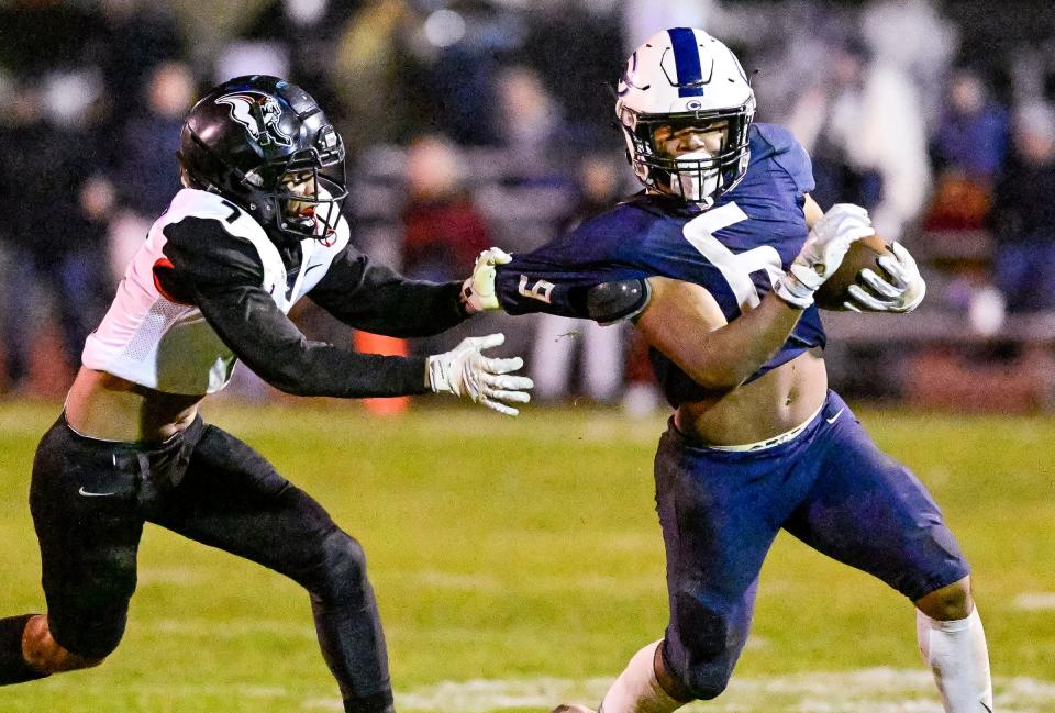 Central Valley Christian's Bryson Donelson gets by Hanford's Dameian Hernandez in a Central Section Division II high school semifinal football playoff Friday, November 18, 2022. 