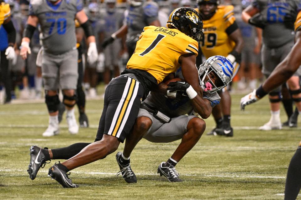 Sep 23, 2023; St. Louis, Missouri, USA; Missouri Tigers defensive back Jaylon Carlies (1) tackles Memphis Tigers wide receiver Demeer Blankumsee (0) during the fourth quarter at The Dome at America's Center. Mandatory Credit: Joe Puetz-USA TODAY Sports