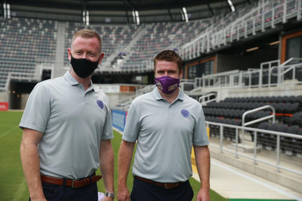 Former Racing Louisville FC head coach Christy Holly, left, poses for a picture with James O'Connor, now president of Soccer Holdings LLC, at Lynn Family Stadium in Louisville, Ky.