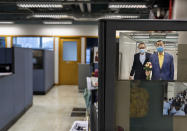 A photo showing Jimmy Lai, right, the founder of Apple Daily is displayed at the news room of Apple Daily Monday, April 26, 2021, in Hong Kong. A newspaper that has advocated for greater democracy in Hong Kong came under further pressure Thursday, June 17, 2021, with the arrests of three top editors and two senior executives.(AP Photo/Vincent Yu)