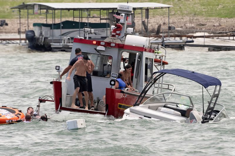 Boats partially submerged from the large wakes of a flotilla of supporters of U.S. President Donald Trump, float in distress during a boat parade on Lake Travis