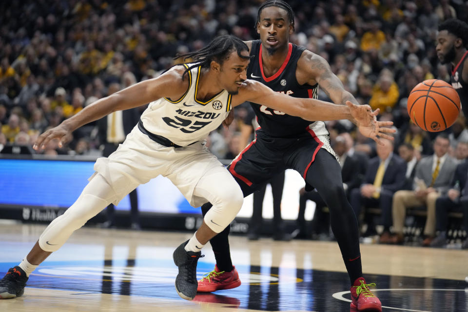 Missouri's Aidan Shaw, left, and Georgia's Jalen DeLoach (23) reach for a loose ball during the second half of an NCAA college basketball game Saturday, Jan. 6, 2024, in Columbia, Mo. Georgia won 75-68. (AP Photo/Jeff Roberson)