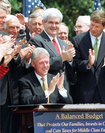 When Clinton signed the Balanced Budget Act of 1997, it was the first time since 1969 that the U.S. had made ends meet. <a href="https://www.gettyimages.com/detail/news-photo/house-majority-leader-newt-gingrich-r-ga-applaudes-us-news-photo/52023875?phrase=clinton%20gingrich" rel="nofollow noopener" target="_blank" data-ylk="slk:Paul Richards/AFP via Getty Images;elm:context_link;itc:0;sec:content-canvas" class="link ">Paul Richards/AFP via Getty Images</a>