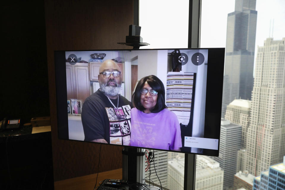 FILE - A monitor displays an image of Veldarin Jackson, Sr. and his mother, Janice Reed, who was one of the three senior victims who died in a Rogers Park building where residents complained of heat, at the office of attorney Larry R. Rogers, Jr., Tuesday, May 24, 2022, in Chicago. As heat waves fueled by climate change arrive earlier, grow more intense and last longer, people over 60 who are more vulnerable to high temperatures are increasingly at risk of dying from heat-related causes. (Jose M. Osorio/Chicago Tribune via AP, File)