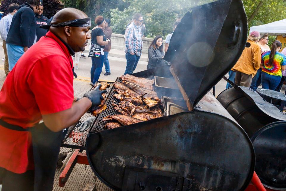 A vendor watches over a smoker at the Muncie Bridge Dinner in 2022.