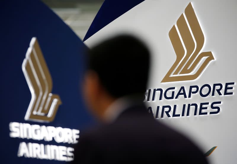 A man walks past a Singapore Airlines signage at Changi Airport in Singapore