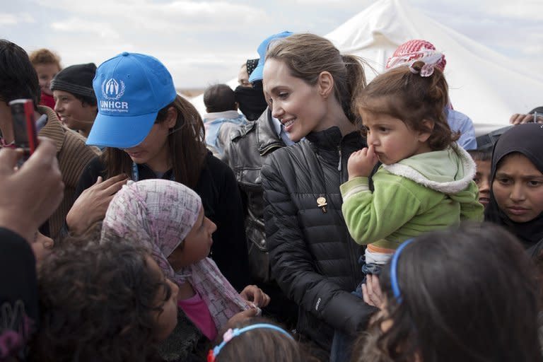 UNHCR Special Envoy Angelina Jolie meets refugees at the Zaatari camp in Jordan, near the border with Syria, on December 6, 2012. Jolie and her partner Brad Pitt have three adopted and three biological children