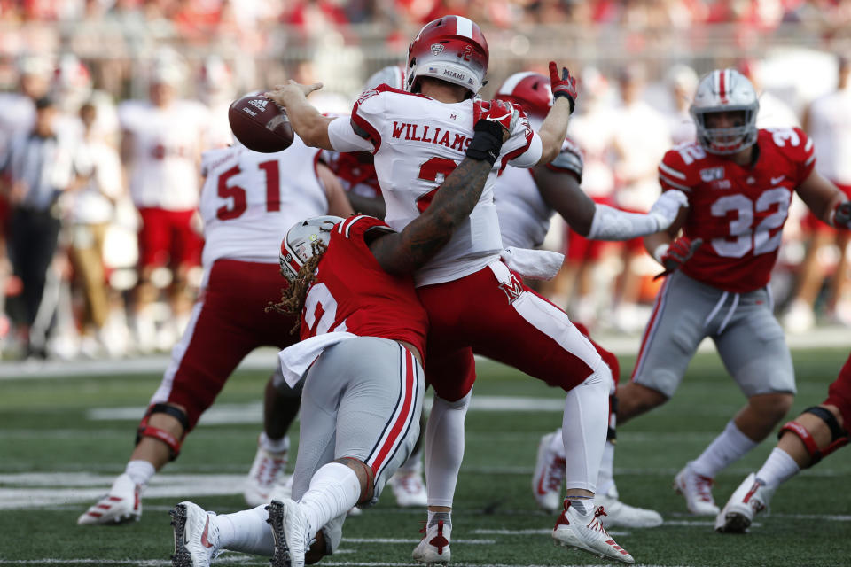 FILE - In this Sept. 21, 2019, file photo, Ohio State defensive end Chase Young, left, sacks Miami (Ohio) quarterback Jackson Williamson causing a fumble during the first half of an NCAA college football game, in Columbus, Ohio. Ohio State said, Wednesday, Nov. 13, 2019, the NCAA has concluded that star DE Chase Young must sit out one more football game before he can return. (AP Photo/Jay LaPrete, File)