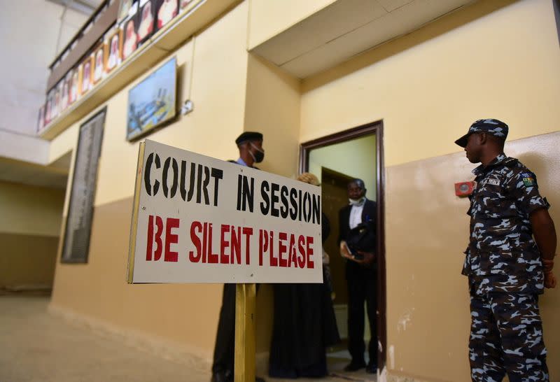 Police officers stand guard at a court during an appeal hearing about a blasphemy conviction, in northern Nigeria's Kano state