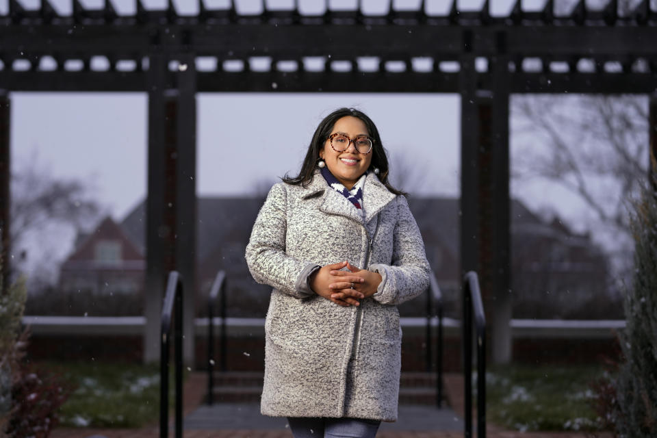 Cynthia Morraz poses on the campus of Indiana University-Purdue University in Indianapolis, Dec. 16, 2020. Morraz a 26-year-old student volunteered to help with early voting there. She feels the incoming administration will be more inclusive, and hopes it will find a permanent solution for young immigrants who arrived as children and are in the country illegally. (AP Photo/Mark Humphrey)