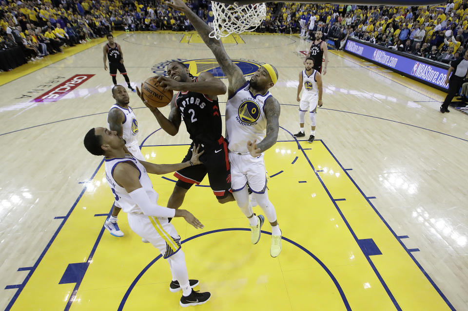 Toronto Raptors forward Kawhi Leonard (2) shoots between Golden State Warriors center DeMarcus Cousins (0) and Shaun Livingston during the second half of during Game 3 of basketball's NBA Finals in Oakland, Calif., Wednesday, June 5, 2019. (AP Photo/Tony Avelar, Pool)