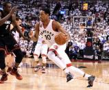 Toronto Raptors guard DeMar DeRozan (10) dribles the ball past Miami Heat forward Luol Deng (9) in game two of the second round of the NBA Playoffs at Air Canada Centre. The Raptors won 96-92. Mandatory Credit: Dan Hamilton-USA TODAY Sports