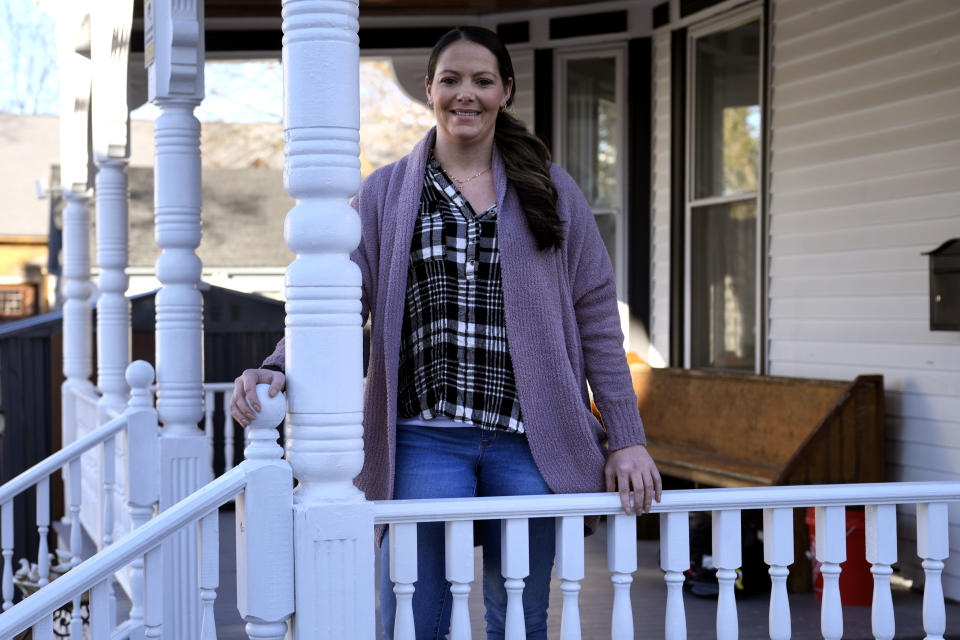Kristina Amyot poses on the porch of a sober-living home, where she resided for about two years, at the Hope on Haven Hill, a residential, outpatient and recovery support service provider for pregnant, post-partum and parenting women, Friday, Jan. 12, 2024, in Rochester, N.H. Amyot, 36, spent more than half her life struggling with addiction, mainly to heroin. Drug overdose deaths in New Hampshire have increased in recent years, and some residents want to hear more from the presidential candidates about how they'd help. (AP Photo/Charles Krupa)