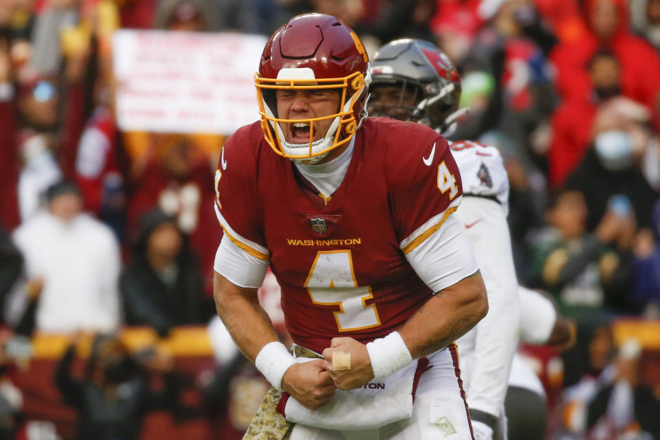 Washington Football Team quarterback Taylor Heinicke (4) celebrates after a Antonio Gibson touchdown in the fourth quarter of an NFL football game against the Tampa Bay Buccaneers, Sunday, Nov. 14, 2021, in Landover, Md. (Shaban Athuman/Richmond Times-Dispatch via AP)