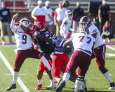 Massachusetts quarterback Garrett Dzuro (9) makes a pass under pressure during the first half of an NCAA college football game against Liberty on Friday, Nov. 27, 2020, at Williams Stadium in Lynchburg, Va. (AP Photo/Shaban Athuman)