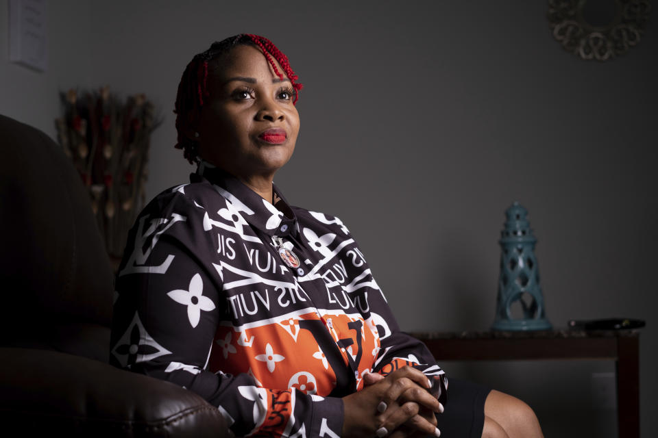 Ebony Brown, whose brother, Isaac E Brown Jr.,, was shot and killed in 2002, poses for a photo in McDonough, Ga., on Aug. 29, 2022. Brown doesn't consider herself a gun lover, but the mother of two is considering purchasing a pistol for protection in case she is ever threatened with a gun. (AP Photo/Ben Gray)