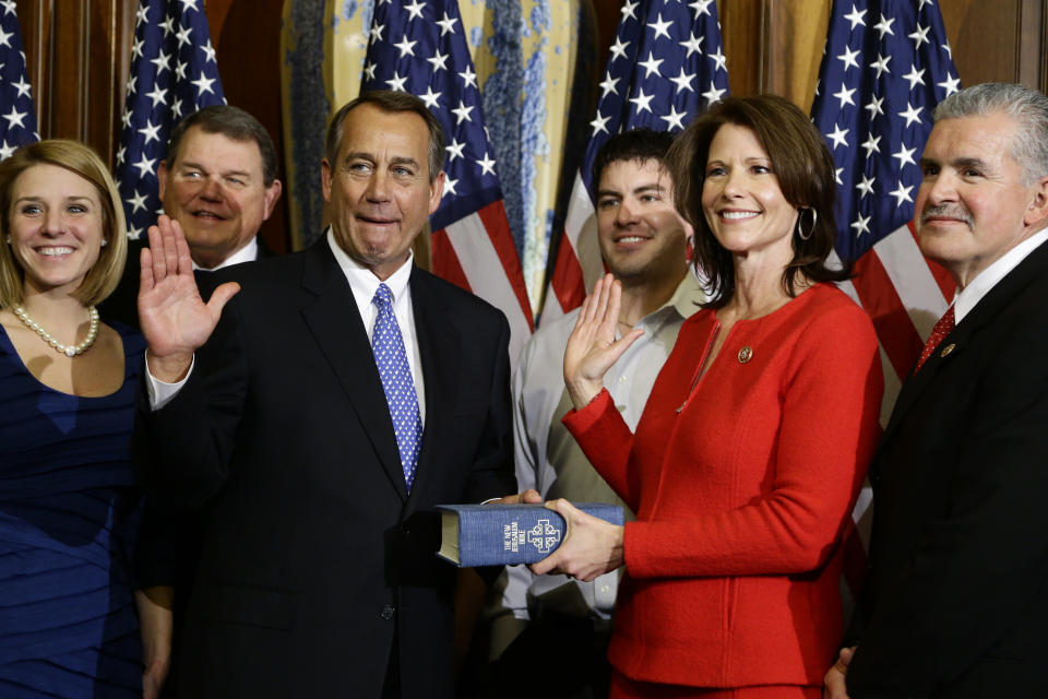 House Speaker John Boehner of Ohio performs a mock swearing in for Rep. Cheri Bustos, D-Ill., surrounded by her family, Thursday, Jan. 3, 2013, on Capitol Hill in Washington, as the 113th Congress began. (AP Photo/Charles Dharapak) 
