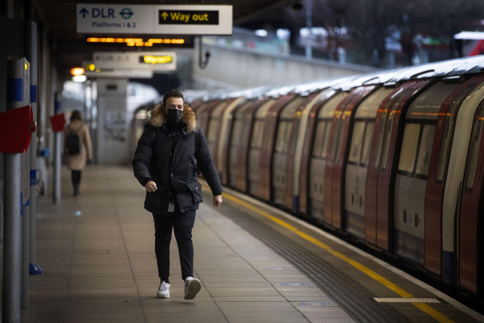 Commuters getting on a Jubilee Line Underground train at Canning Town station during the morning rush hour in London, as England's third national lockdown to curb the spread of coronavirus continues.